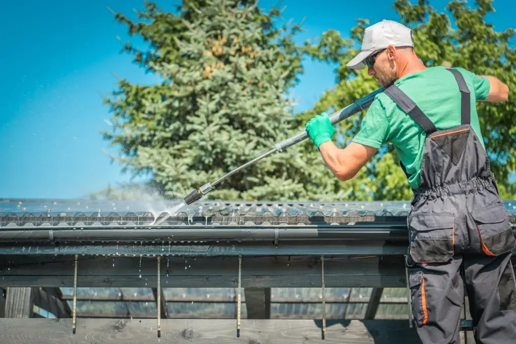 Image of roofing technician performing gutter cleaning
